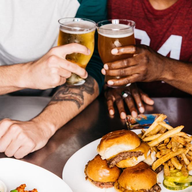 Sports fans toast over burgers and beer.