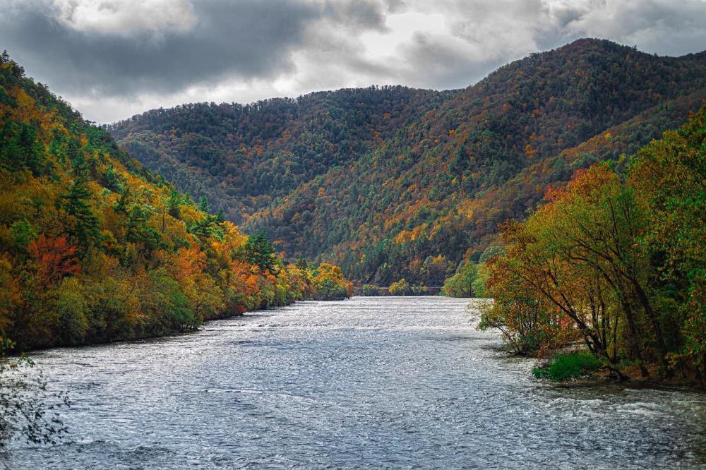 French Broad River surrounded by fall colored mountains near Asheville