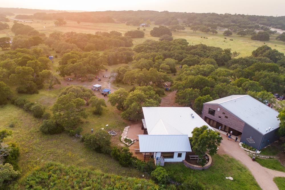 Aerial view of Vista Brewing taproom, brewery and beer garden with rolling hills and lush green trees.