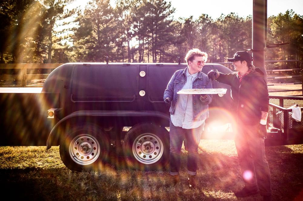 la Barbecue owners LeAnn Mueller and Alison Clem in front of smoker