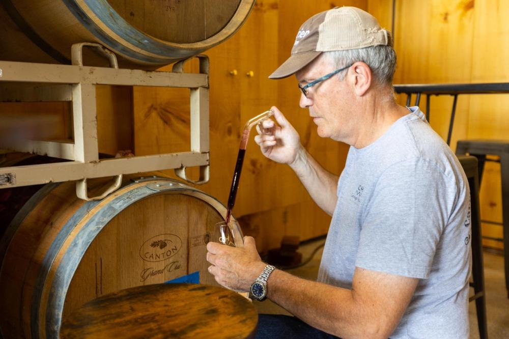 Mike Fritze draws a sample of red wine directly from an oak barrel at a Carraige House Wineworks in Loudoun County during the Annual Loudoun Barrel Tasting event.
