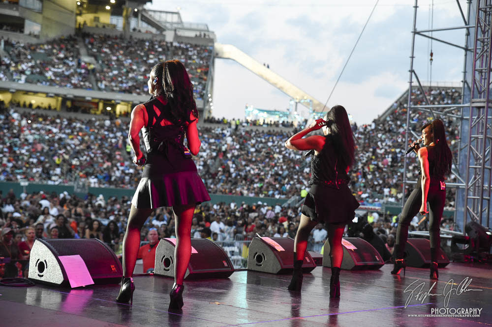 Three performers seen from the back on a stage at Paul Brown Stadium at Cincinnati Music Festival