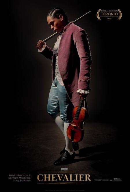 a muscician holds a violin wearing 18th century clothing