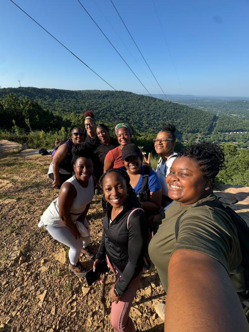 Group of hikers taking a selfie at a scenic overlook at Blevins Gap Nature Preserve in Huntsville.