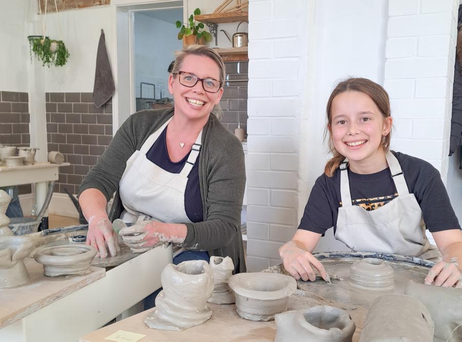 Mother and daughter at Honeybourne Pottery, using the potters wheels