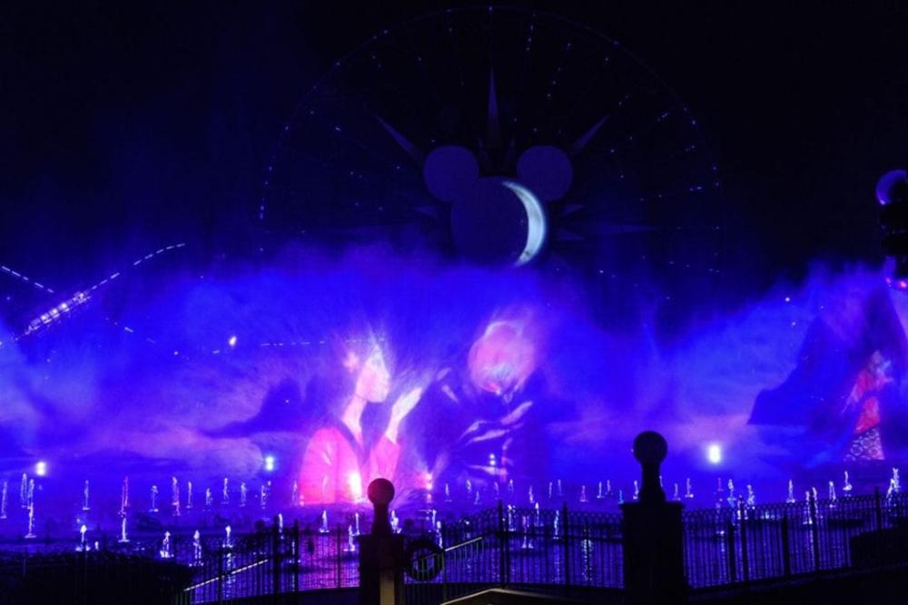 Image of World of Color at Disney California Adventure Park. The image shows a 'screen' made of mist with an image being shown through the mist from the movie 'Mulan.'