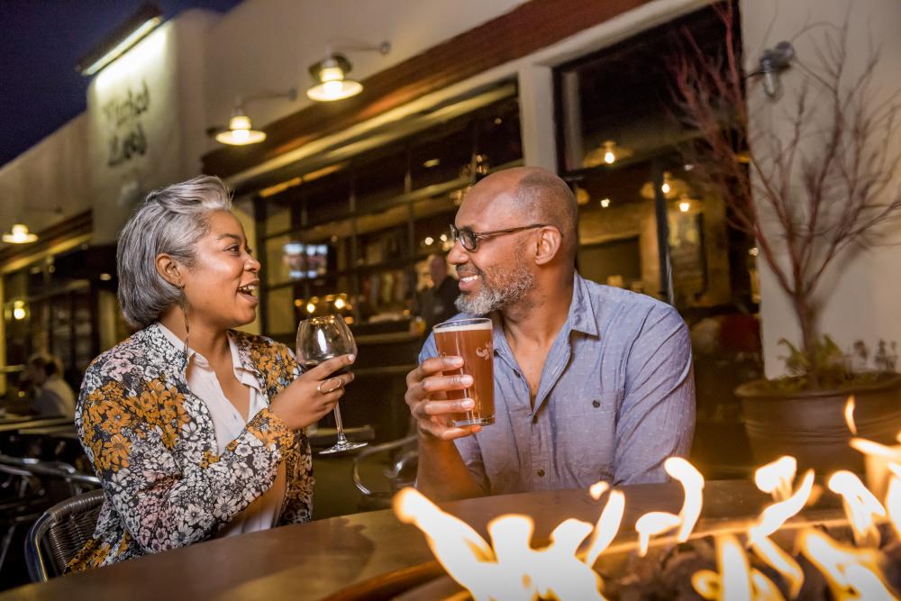 Couple by Fire Pit at Wicked Weed Brewing