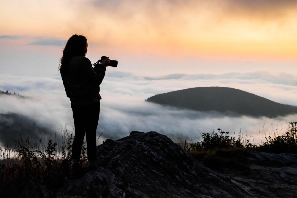 A photographer at sunset along the Blue Ridge Parkway near Asheville, NC