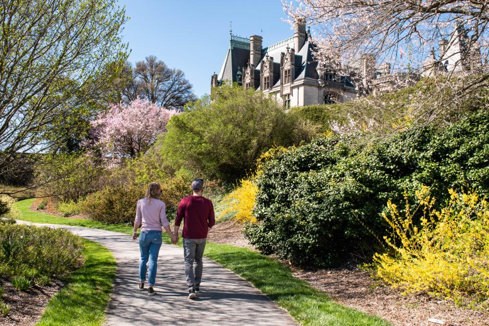A couple strolls the grounds of Biltmore during the Biltmore Blooms celebration