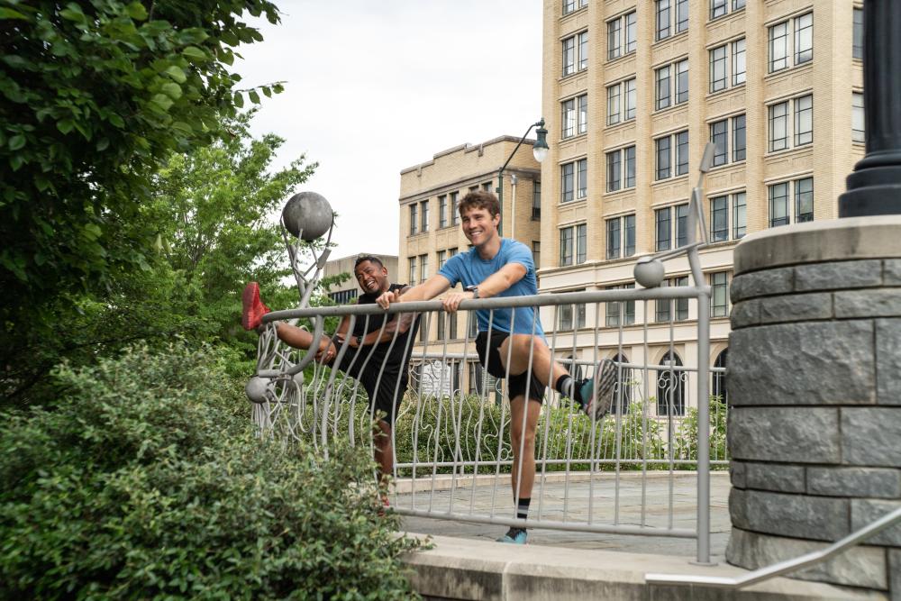 Two runners stretching in downtown Asheville