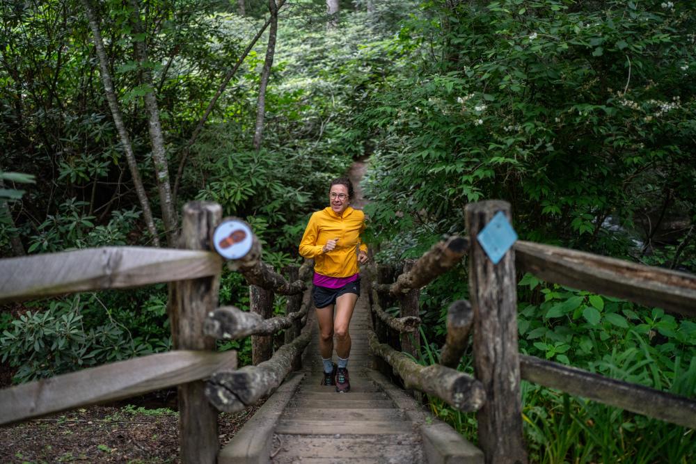 Woman running up stairs on trail in Montreat