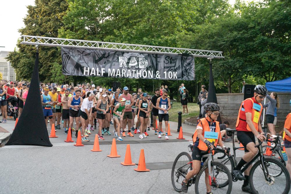 Runners starting at the starting line at the River Arts District Marathon and 10K