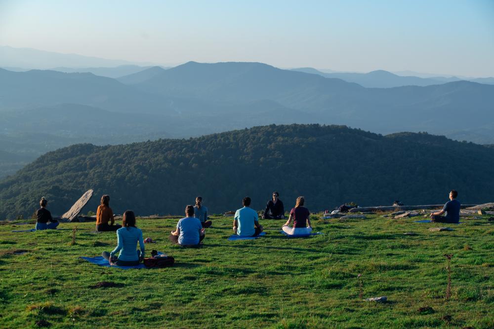 People doing mountaintop yoga on Bearwallow Mountain