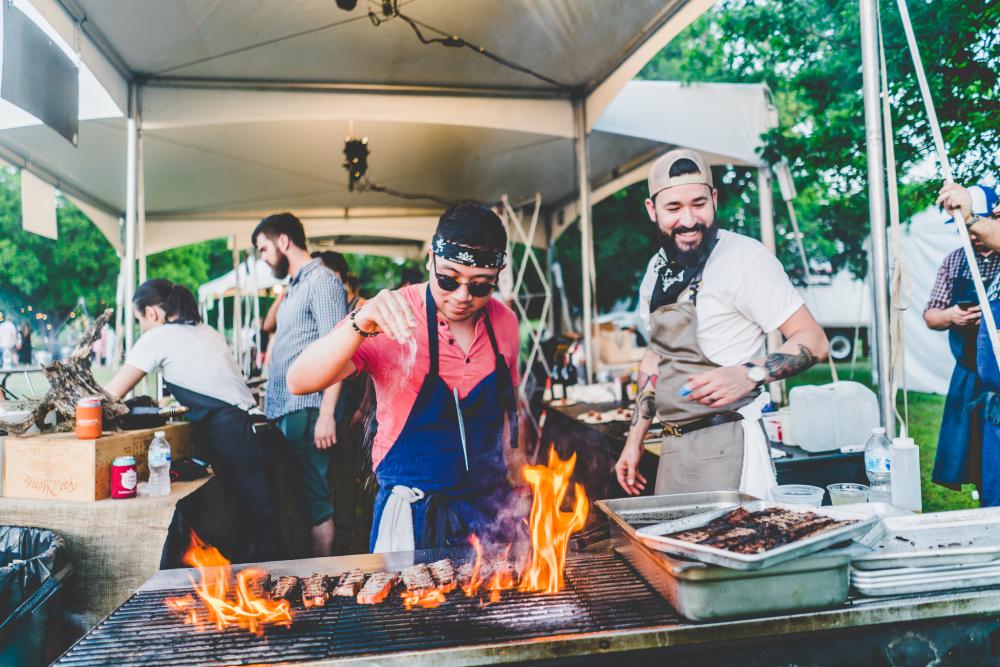 chef cooks on grill at Al Fuego event for Hot Luck Food and music festival in austin texas