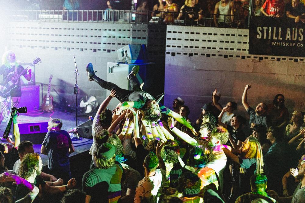 Image of a man crowdsurfing at Mohawk.