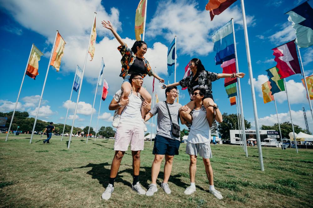 A group of people in front of flags at ACL Austin City Limits Music Festival in Austin, Texas