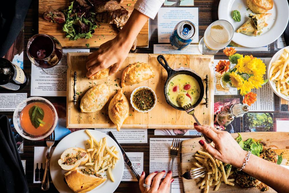 table full of food at Buenos Aires Cafe in austin texas