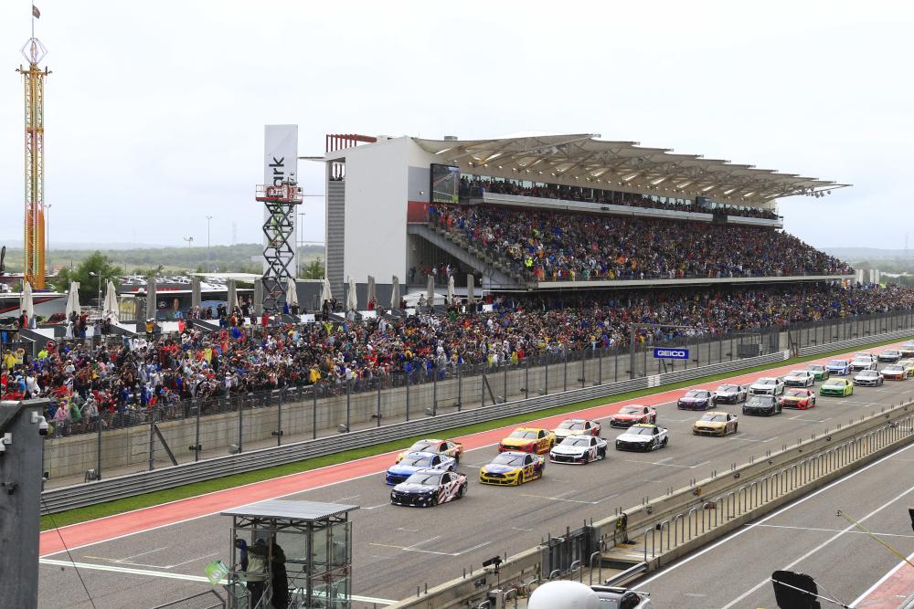 NASCAR vehicles lined up in front of COTA's Grandstand.