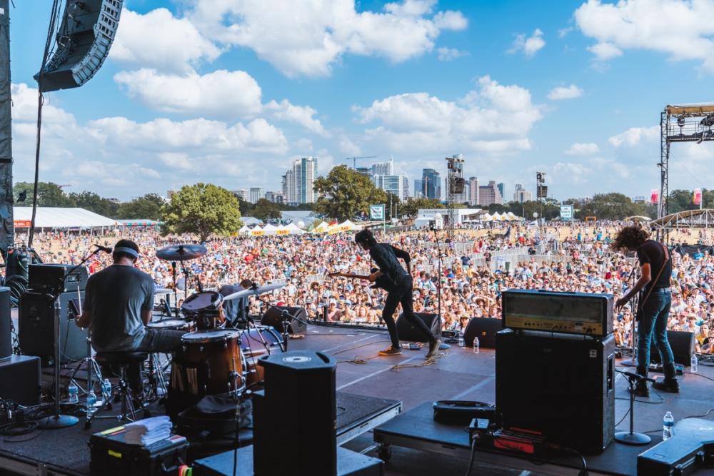 Band performing on stage looking out to crowd at ACL music Fest austin texas