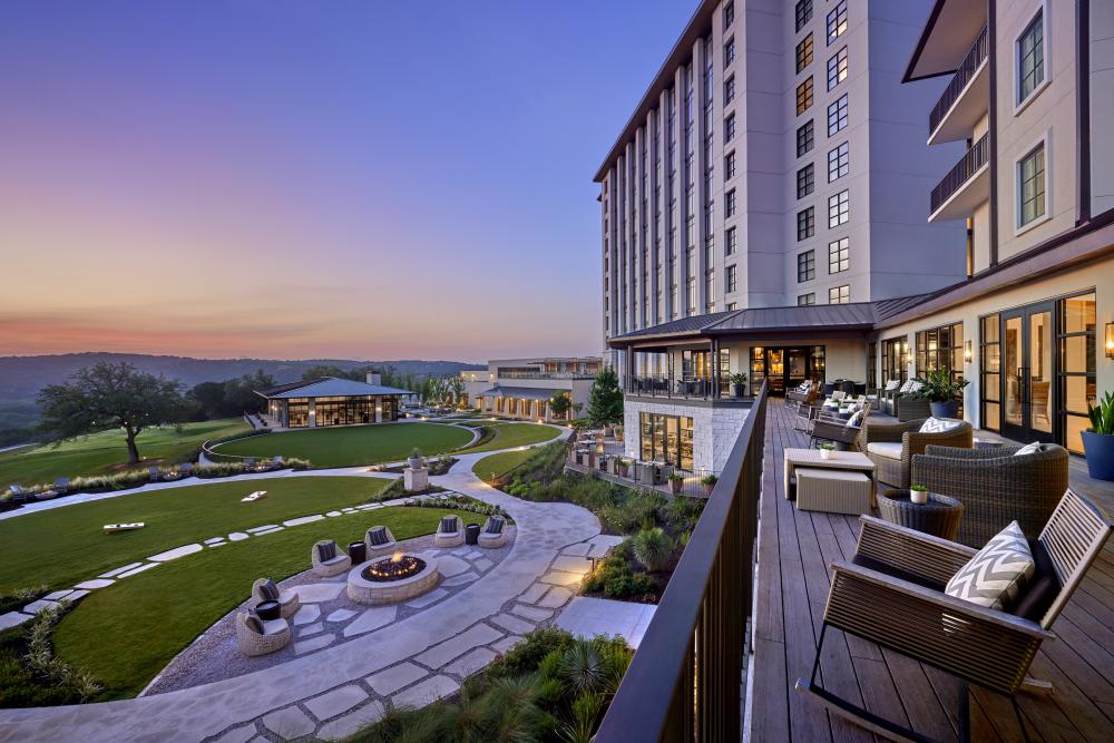 Hotel patio deck overlooking firepits and rolling Hill Country.