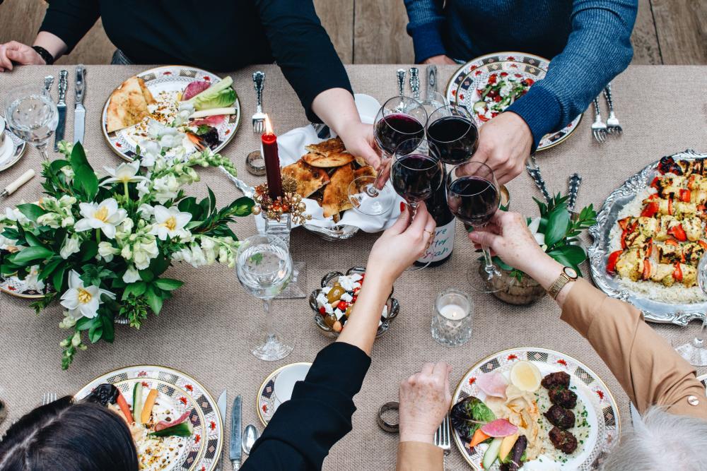 Family toasts wine over Christmas Eve Dinner from Aba in Ausitn Texas