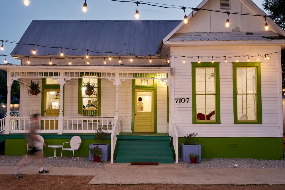 Exterior of home-turned-restaurant with twinkle lights.