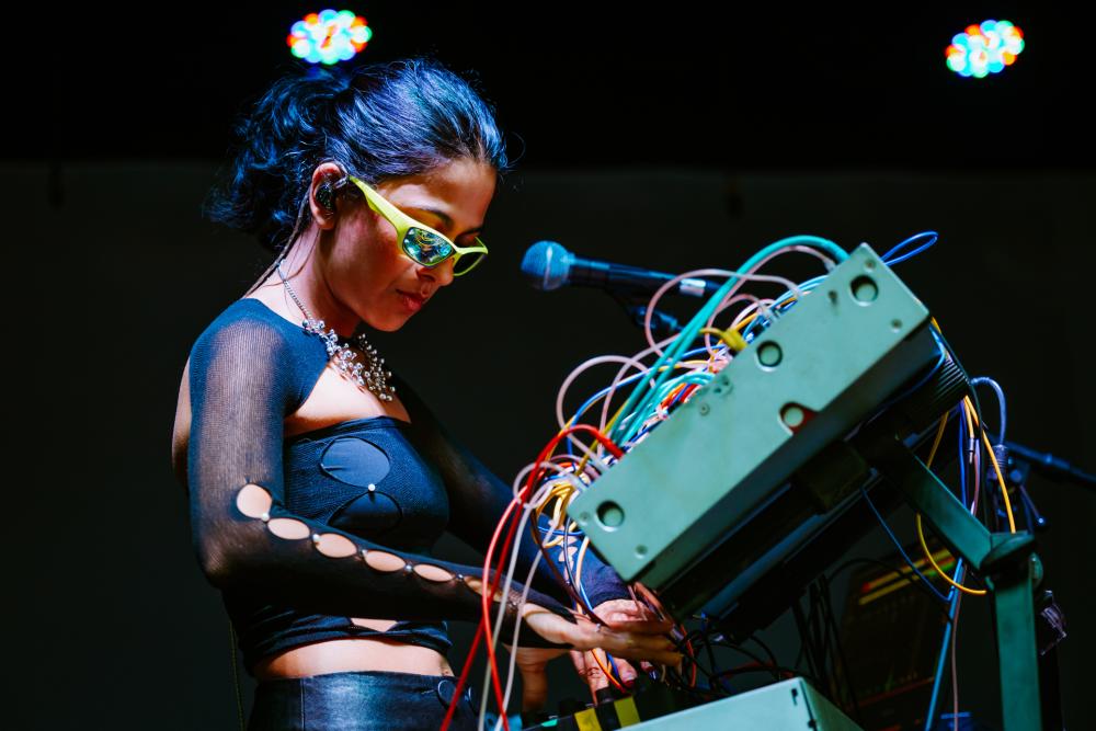 Arushi Jain playing on a synth instrument on a stage.
