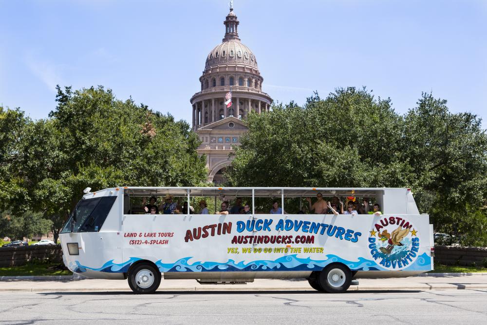 Austin Duck Adventures vehicle/boat in front of the Texas State Capitol buidling.
