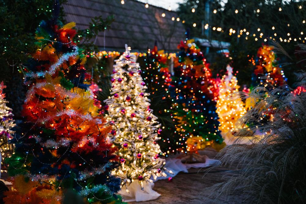 Rainbow colored Christmas trees with neon lights lining the Austin Motel pool deck.