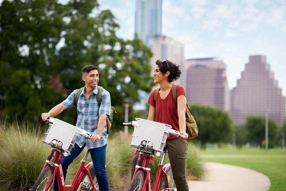 Pair biking on the Butler Hike and Bike Trail in downtown Austin, Texas