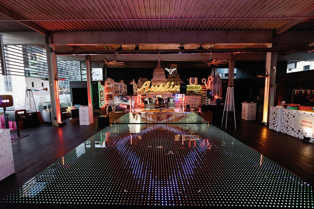 LED dance floor in front of an Austin-themed stage on the rooftop of Brazos Hall.