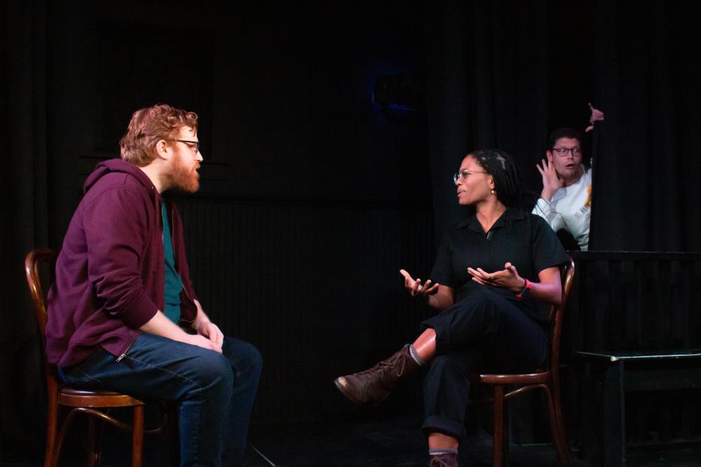 Improv comedians acting on a stage.