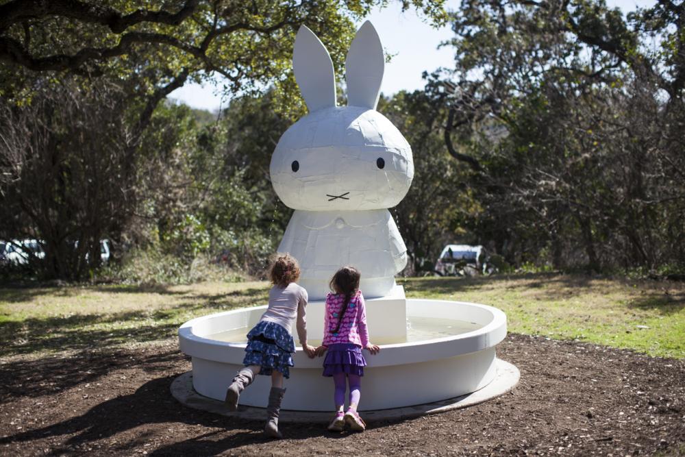 Children enjoy a sculpture at The Contemporary Austins Betty and Edward Marcus Sculpture Park at Laguna Gloria