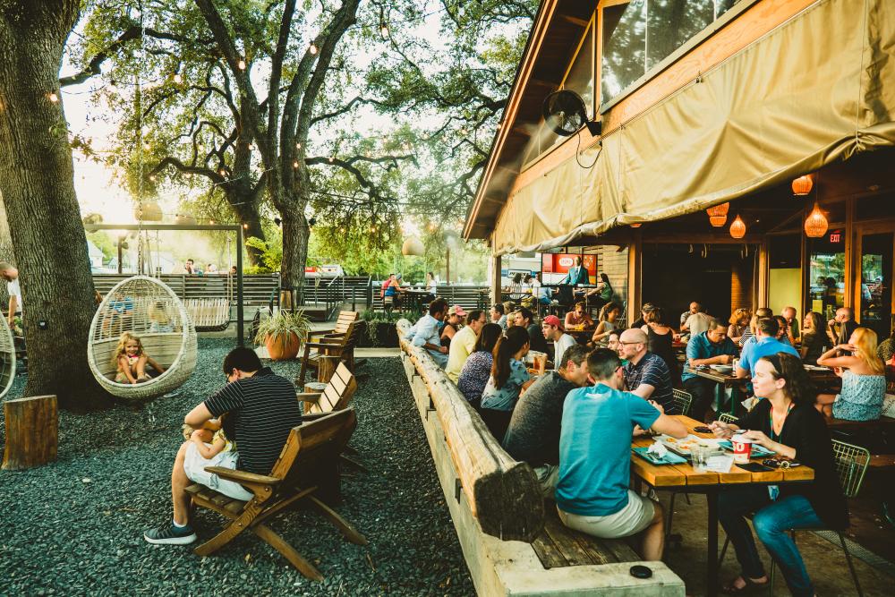 people dining on the patio at Loro in austin texas