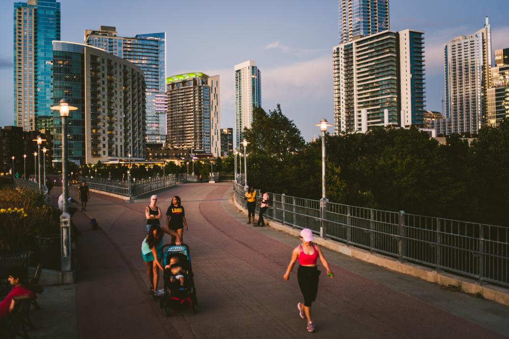 People walking and biking on the Pedestrian Bridge at the Bike and Bike Trail in Austin Texas