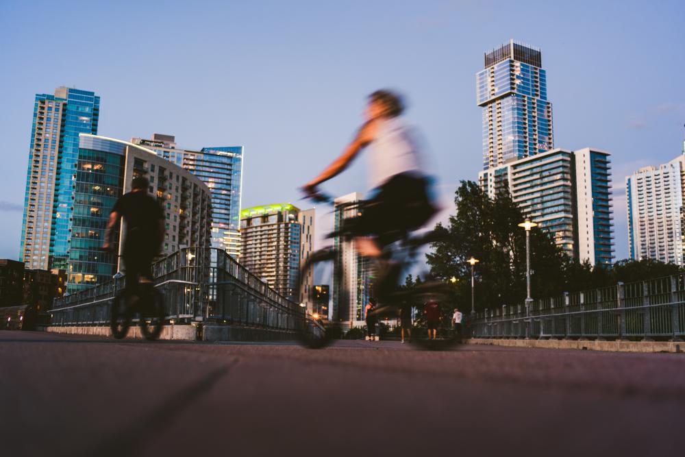 People biking on the Pfluger Pedestrian Bridge in Austin Texas
