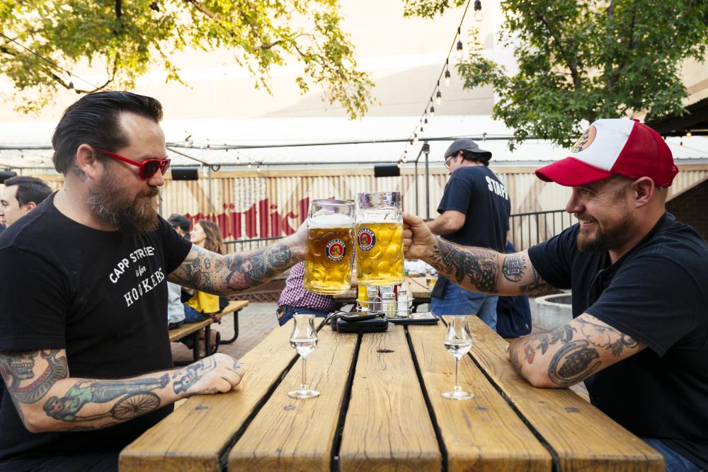 Friends enjoy pints of beer at Scholz Garten in Austin, Texas