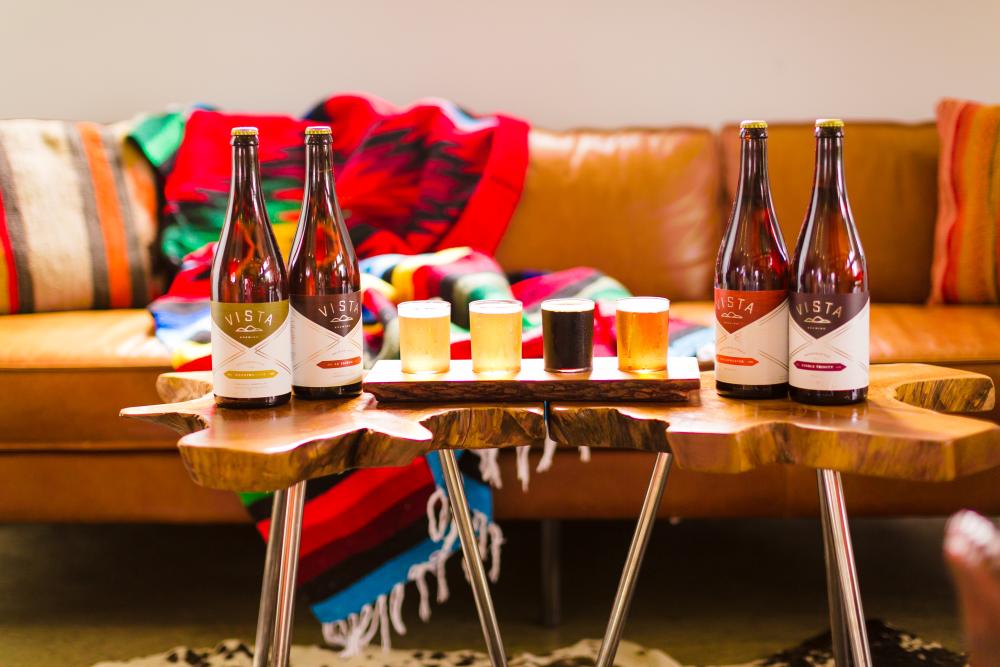 Bottles and pours on coffee table at Vista Brewing near Austin Texas