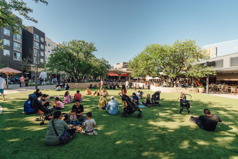 people picnicking on the Northside Lawn at the Domain NORTHSIDE shopping area