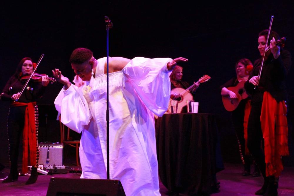 Dorian Wood performing on stage with all female mariachi band in background at OUTsider Fest 2019