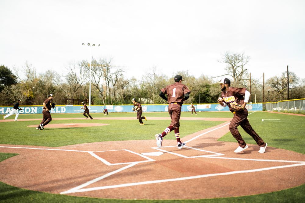 Baseball players in action during a game at Downs Field