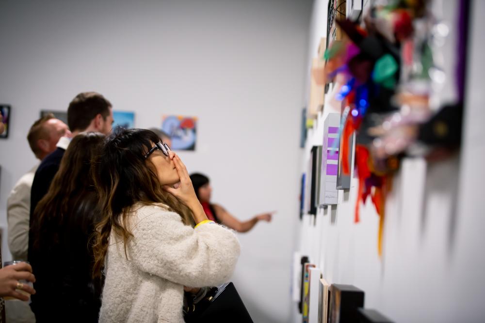 Woman looking at artwork during East Austin Studio Tour in austin texas