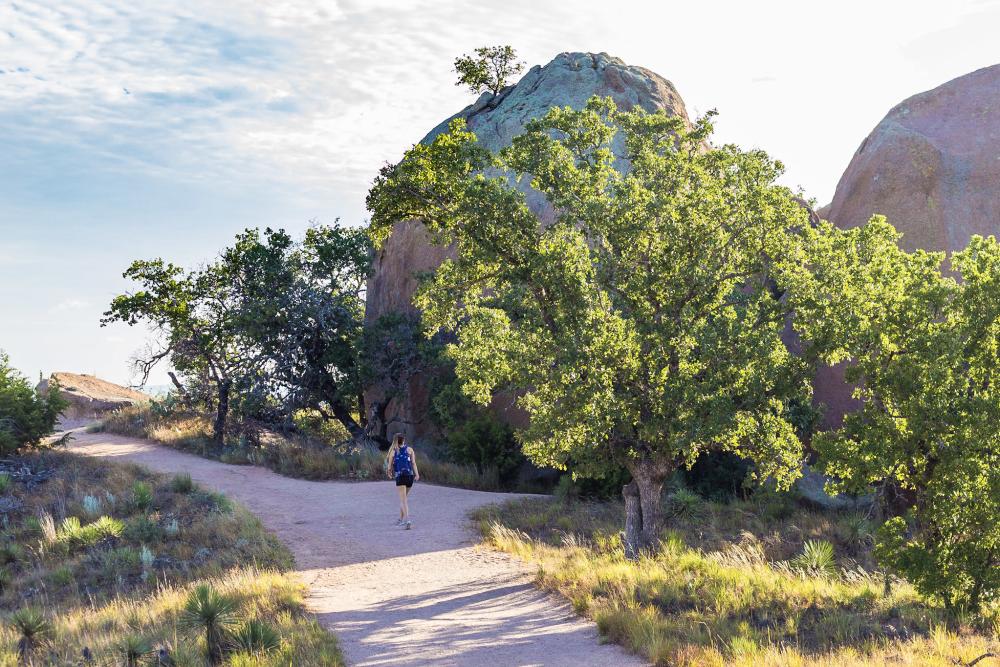 Woman on hiking trail at Enchanted Rock state park outside of Fredericksburg Texas