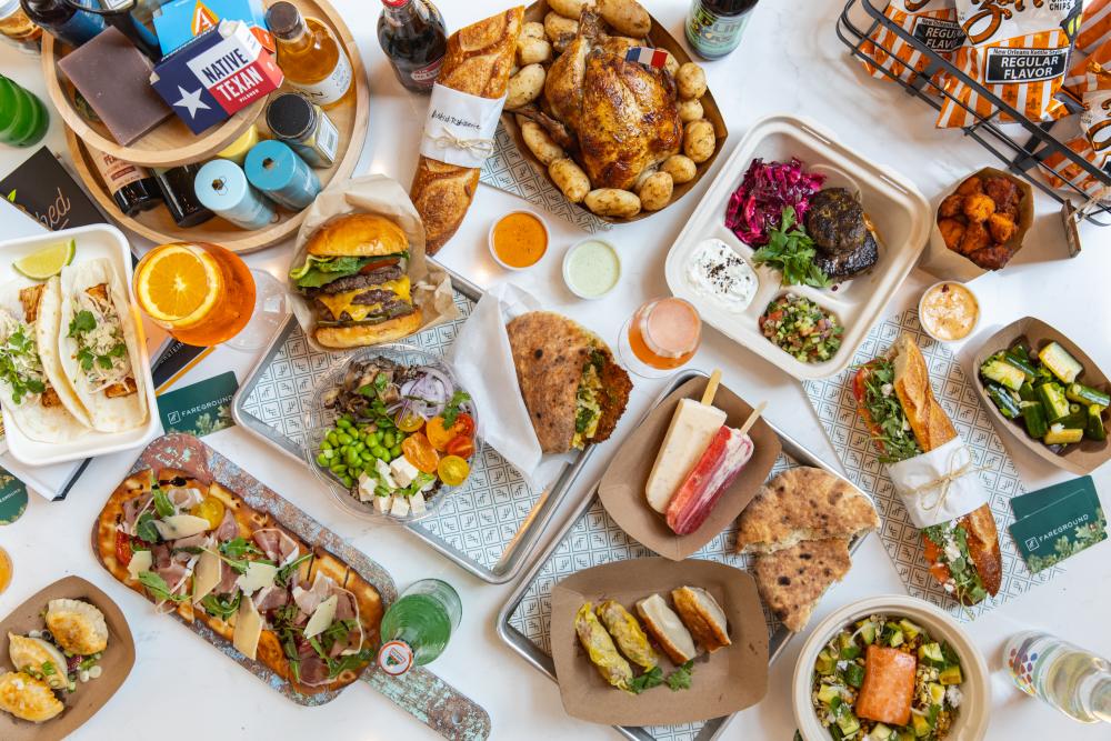 Overhead view of various dishes and beverages from Fareground's food vendors