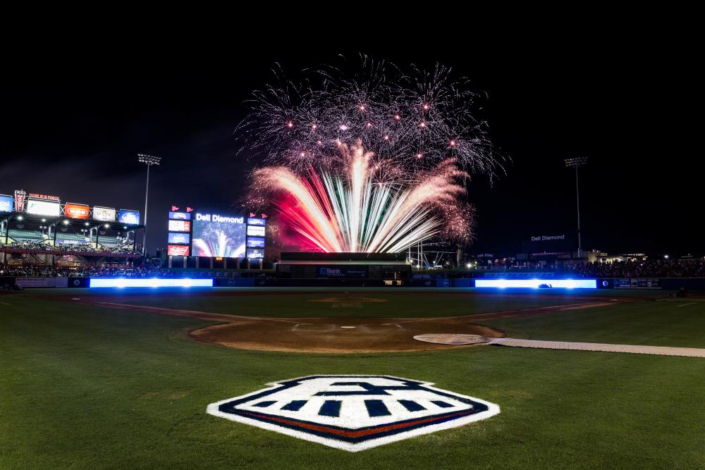 Fireworks erupting behind the Round Rock Express baseball field.
