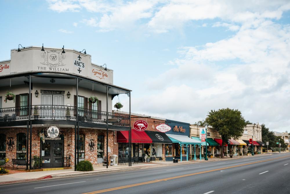 Photo of shops in downtown Boerne, on the Hill Country Mile. Shops include Jac's, Cypress Grille, The Alley on Main, Ella Blue and others