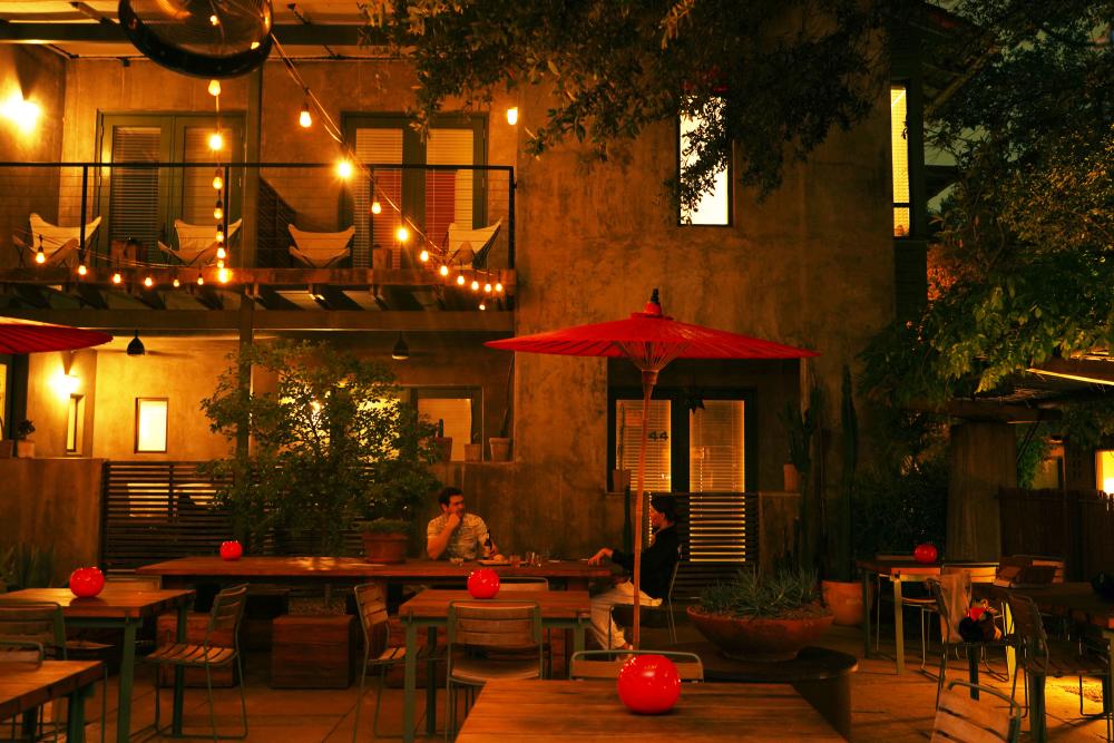Dimly lit courtyard at Hotel San Jose with string lights.