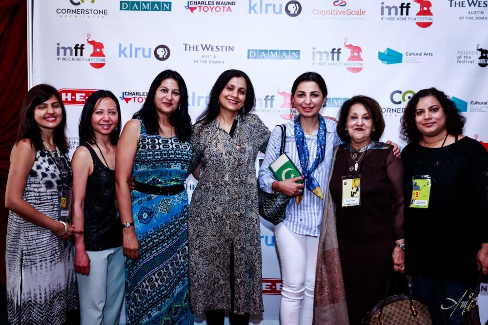Women attendees gathered in front of logoed backdrop for Indie Meme Film Festival 2019.