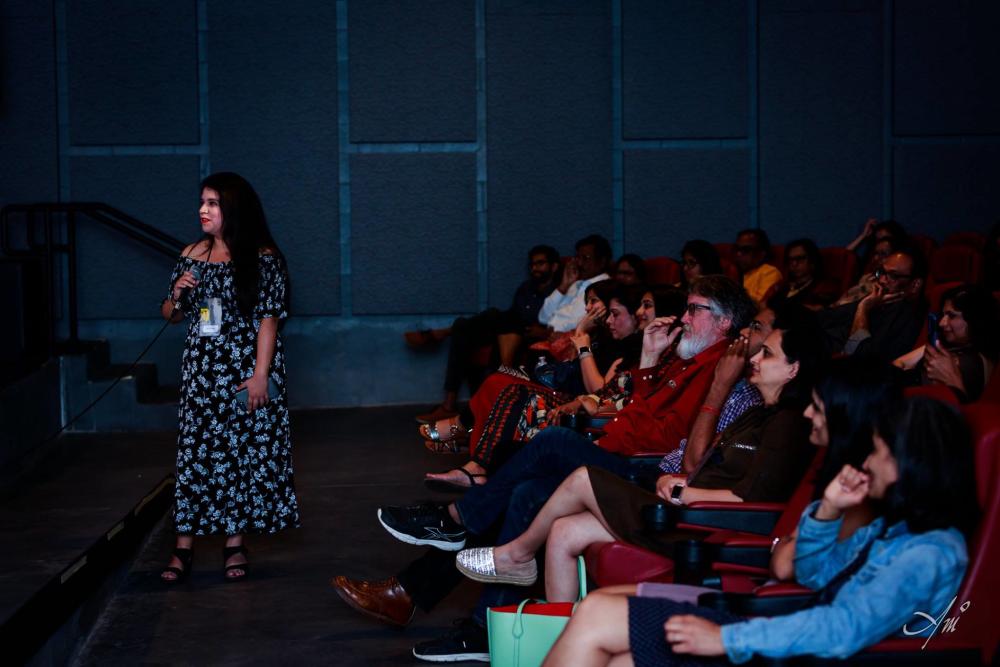 Audience watching woman speak at IMFF 2019.
