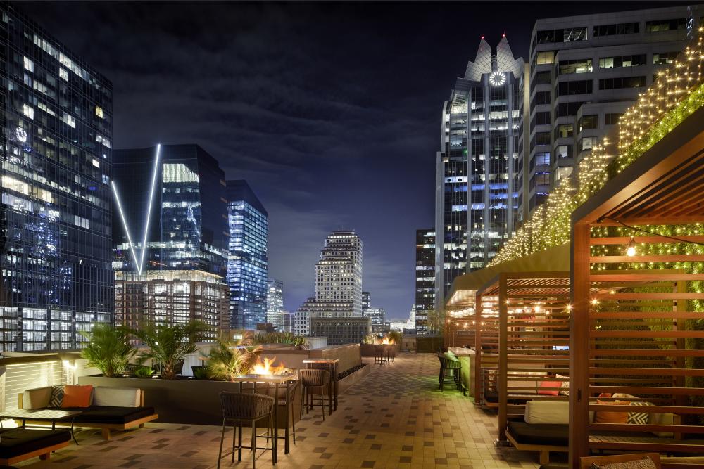 JW Marriott Austin outdoor pool deck, looking at the night time skyline.